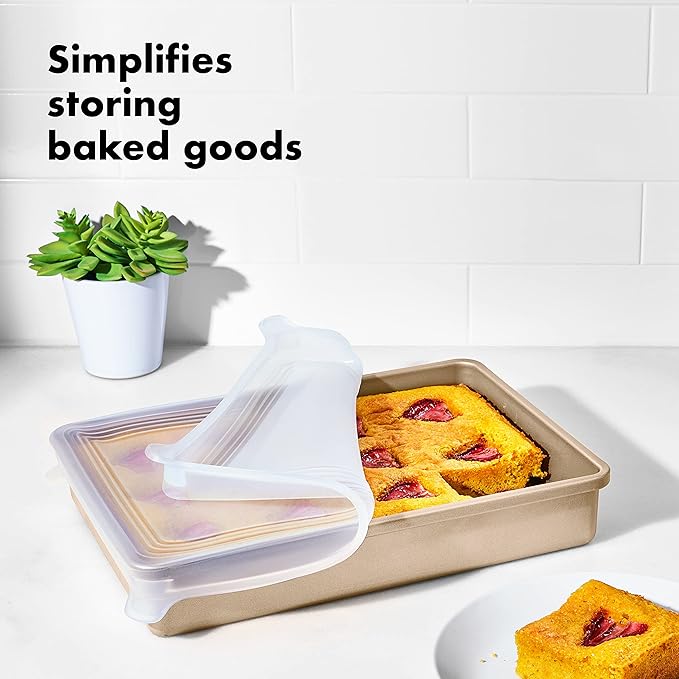 OXO Good Grips silicone baking pan lid on a 9x13 cake pan with baked squares, designed for airtight storage and transport.