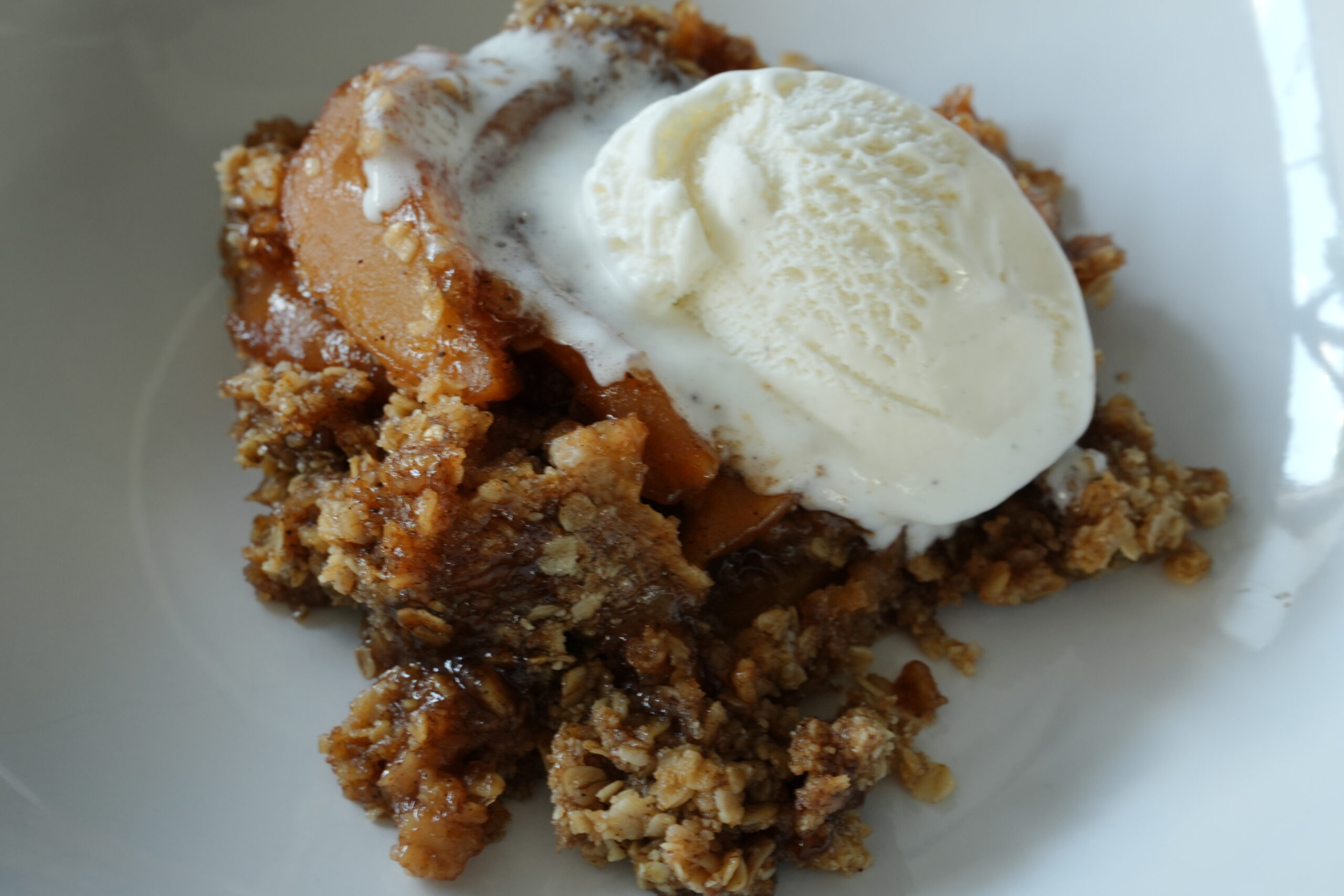 Slow Cooker Apple Crisp in white bowl