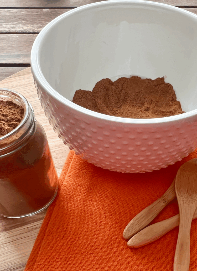Homemade pumpkin pie spice blend mixed in a bowl – cinnamon, nutmeg, allspice, and cloves ready for use