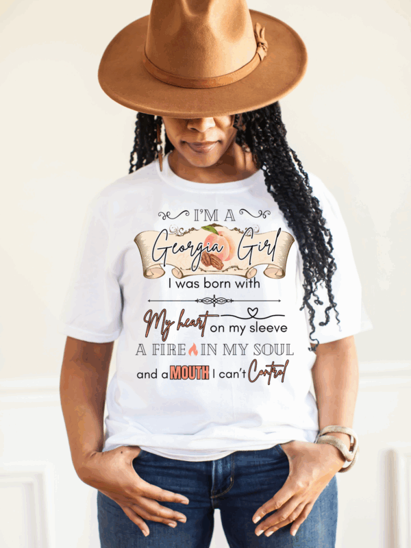 Woman wearing Georgia Girl Graphic Tee in white with hat and jeans.