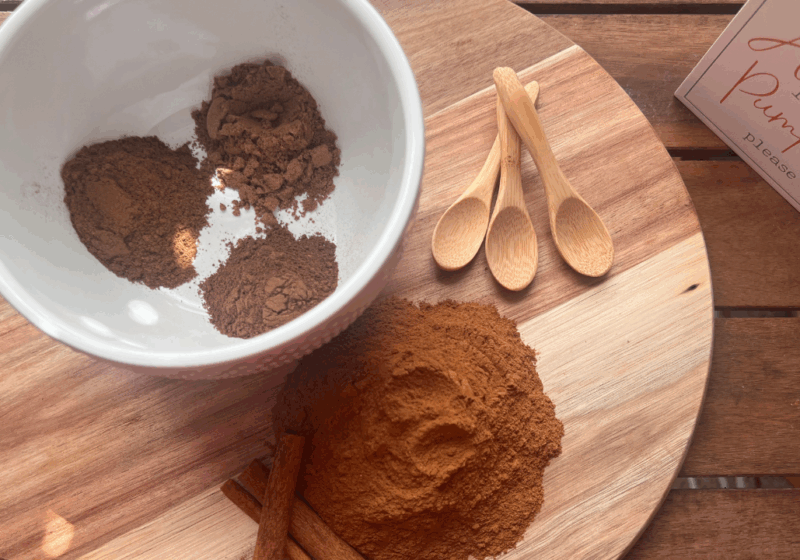 Ingredients for homemade pumpkin pie spice separated on a cutting board – ground cinnamon, nutmeg, allspice, and cloves ready for mixing